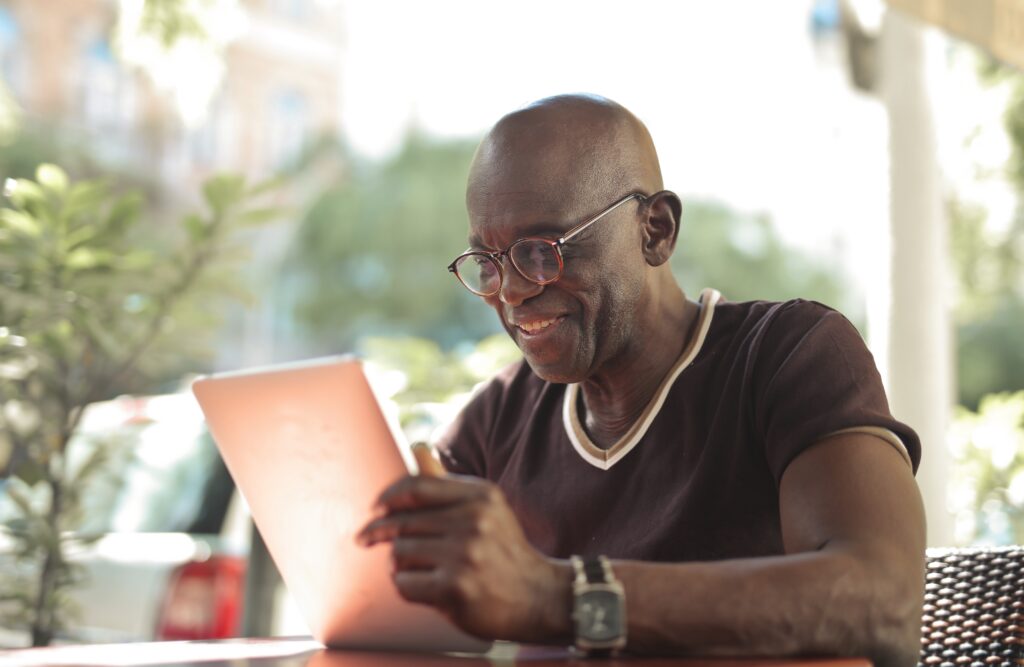 mature man with a tablet in an outdoor cafe