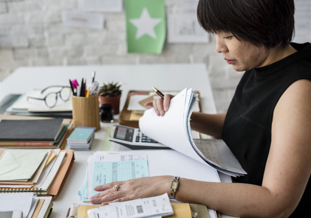 Adult asian woman working on payment bills accounting summary data